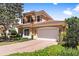 Two story home with brick driveway and lush landscaping at 26142 Avenida Las Colinas # 2B, Howey In The Hills, FL 34737