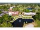 Luxury resort with multiple buildings, a lake, and lush landscaping at 26142 Avenida Las Colinas # 2B, Howey In The Hills, FL 34737