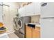 Bright laundry room, featuring washer, dryer, and extra storage at 26142 Avenida Las Colinas # 2B, Howey In The Hills, FL 34737