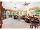 Spacious living room with leather furniture and access to a balcony at 26142 Avenida Las Colinas # 2B, Howey In The Hills, FL 34737