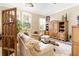 Spacious living room with a sofa, chairs, and built-in shelving at 26142 Avenida Las Colinas # 2B, Howey In The Hills, FL 34737