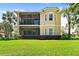 Two-story house with screened balcony and a well-maintained lawn at 26142 Avenida Las Colinas # 2B, Howey In The Hills, FL 34737