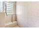 Walk-in shower with tiled walls, built-in seat, and window at 26142 Avenida Las Colinas # 2B, Howey In The Hills, FL 34737