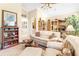 Spacious living room with a sofa, chairs, and built-in shelving at 26142 Avenida Las Colinas # 2B, Howey In The Hills, FL 34737
