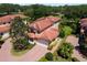 Two-story house with tile roof, driveway, and landscaping at 26142 Avenida Las Colinas # 2B, Howey In The Hills, FL 34737