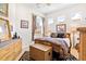 Spacious bedroom with a wicker dresser and patterned bedding at 26142 Avenida Las Colinas # 2B, Howey In The Hills, FL 34737