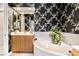 Spa-like bathroom featuring a large soaking tub and wood vanity at 26142 Avenida Las Colinas # 2B, Howey In The Hills, FL 34737