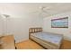 Cozy bedroom with wood flooring and ceiling fan at 9930 County Road 114B, Wildwood, FL 34785