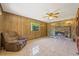 Cozy living room with a fireplace and recliner at 9930 County Road 114B, Wildwood, FL 34785