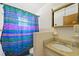 Bathroom with shower and granite countertop at 9930 County Road 114B, Wildwood, FL 34785