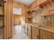 Retro kitchen with wood cabinets and a built-in sink at 9930 County Road 114B, Wildwood, FL 34785