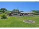 Ranch-style home with carport and manicured lawn at 9930 County Road 114B, Wildwood, FL 34785