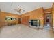 Gathering room with wood paneling and built-in shelving at 9930 County Road 114B, Wildwood, FL 34785