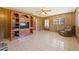 Living room with wood paneling and built-in shelving at 9930 County Road 114B, Wildwood, FL 34785