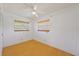 Well-lit bedroom with light wood flooring and ceiling fan at 9930 County Road 114B, Wildwood, FL 34785