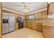 Kitchen with stainless steel appliances and wood cabinets at 9930 County Road 114B, Wildwood, FL 34785