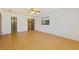 Spacious bedroom with light wood flooring and ample closet space at 9930 County Road 114B, Wildwood, FL 34785