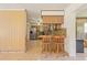 Kitchen features wood cabinets, granite countertops, and a breakfast bar at 9930 County Road 114B, Wildwood, FL 34785