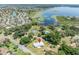 Aerial view showing home's location, large lot, and lake proximity at 9930 County Road 114B, Wildwood, FL 34785