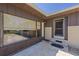 House exterior featuring a brown and brick facade, a spacious window, and a screen door at 9930 County Road 114B, Wildwood, FL 34785