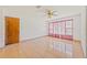 Spacious bedroom with tile floors and large windows at 9930 County Road 114B, Wildwood, FL 34785