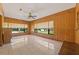Gathering room with wood paneling and large windows at 9930 County Road 114B, Wildwood, FL 34785