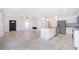 Open concept kitchen and living room with modern appliances and fireplace at 502 St Johns Ct, Poinciana, FL 34759