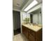 Updated bathroom with wood vanity and a large mirror at 1921 Smitty Rd, Lady Lake, FL 32159