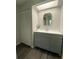 Bathroom with gray vanity, mirror, and linen closet at 1921 Smitty Rd, Lady Lake, FL 32159