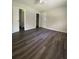 Spacious bedroom with dark gray vinyl flooring at 1921 Smitty Rd, Lady Lake, FL 32159