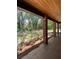 Covered porch with brick columns and wood ceiling; view of backyard at 1921 Smitty Rd, Lady Lake, FL 32159