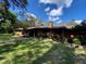 Brick ranch house with covered entry and landscaped yard at 1921 Smitty Rd, Lady Lake, FL 32159
