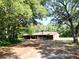 Ranch style home with brick exterior and mature landscaping at 1921 Smitty Rd, Lady Lake, FL 32159