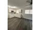Open living room with gray vinyl flooring at 1921 Smitty Rd, Lady Lake, FL 32159