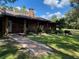 Brick ranch house with walkway, landscaping, and a chimney at 1921 Smitty Rd, Lady Lake, FL 32159