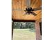 Covered patio with wooden ceiling and a ceiling fan, overlooking the backyard at 1921 Smitty Rd, Lady Lake, FL 32159