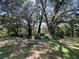 Large grassy yard with mature oak trees and shade at 1921 Smitty Rd, Lady Lake, FL 32159