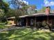 Brick ranch house with walkway, landscaping, and a chimney at 1921 Smitty Rd, Lady Lake, FL 32159