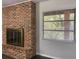 Brick fireplace with glass doors in a living room, adding warmth and character at 1921 Smitty Rd, Lady Lake, FL 32159