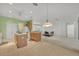 Kitchen with island, light wood cabinets, and views into adjoining living areas at 12176 Se 91St Ave, Summerfield, FL 34491