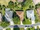 Aerial shot of a house nestled in a neighborhood with mature trees at 12176 Se 91St Ave, Summerfield, FL 34491
