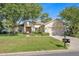 Single-story house with a two-car garage and manicured lawn at 12176 Se 91St Ave, Summerfield, FL 34491