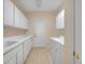 Laundry room with washer, dryer, cabinets, and sink at 12176 Se 91St Ave, Summerfield, FL 34491