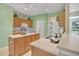 Eat-in kitchen with ample counter space, light wood cabinets, and a full appliance package at 12176 Se 91St Ave, Summerfield, FL 34491