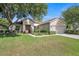 Single-story house with a two car garage and landscaped yard at 12176 Se 91St Ave, Summerfield, FL 34491