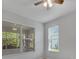 Bright bedroom with ceiling fan and large windows at 12176 Se 91St Ave, Summerfield, FL 34491