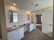 Double vanity bathroom with white cabinets, mirrors, and tile flooring at 4422 Cr 690, Webster, FL 33597