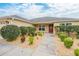 House exterior showcasing a manicured lawn and walkway at 5596 Cedar Waxwing Dr, The Villages, FL 32163