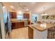 Spacious kitchen with granite countertops and stainless steel appliances at 5596 Cedar Waxwing Dr, The Villages, FL 32163