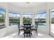 Breakfast nook with a round table and chairs, overlooking the pool area at 29334 David Ct, Tavares, FL 32778